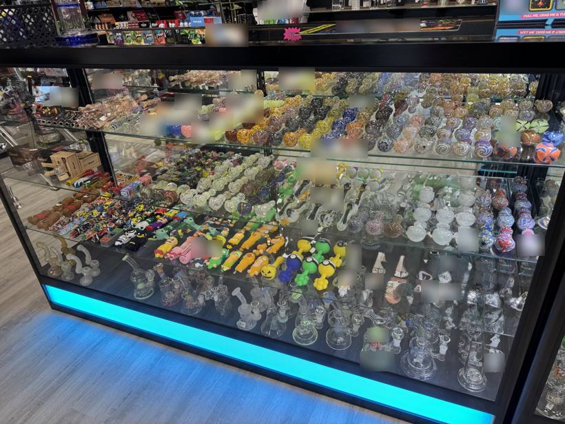Glass display case of hand pipes and novelty glass